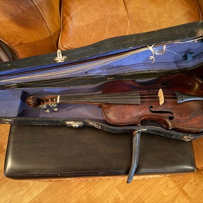 Sale Photo Thumbnail #118: Vintage dark stain wooden violin with bow inside a blue velvet-lined hard case.