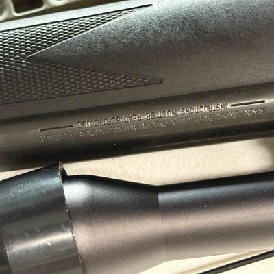 Sale Photo Thumbnail #35: Black synthetic stock muzzleloader rifle barrel with a scope, 