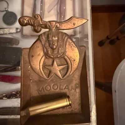 Sale Photo Thumbnail #123: Vintage cast metal Shriners Moolah temple coin tray featuring the scimitar, pharaoh, crescent, and star emblem.