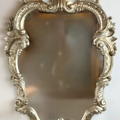 Sale Photo Thumbnail #220: Vintage Rococo-style wall mirror with an ornate gilt frame and acanthus leaf cresting.