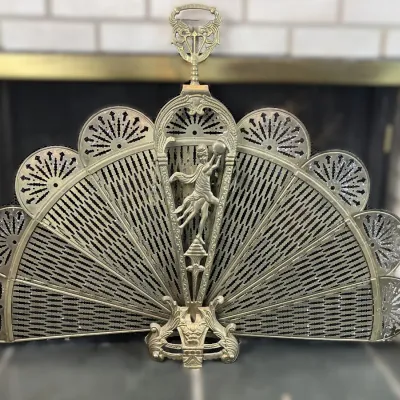 Sale Photo Thumbnail #74: Vintage brass folding peacock fan fireplace screen featuring intricate filigree leaves and a relief sculpture figure on the central post.