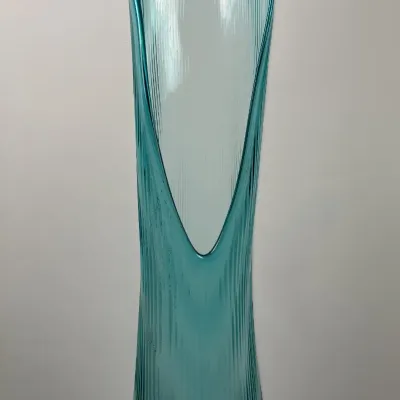 Sale Photo Thumbnail #35: Mid-century modern turquoise swung glass floor vase featuring a ribbed textured pattern and a pulled open lip.