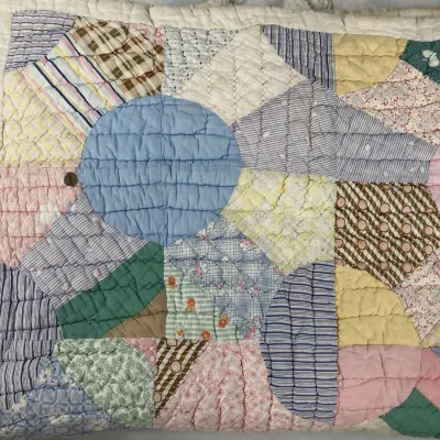 Sale Photo Thumbnail #175: Vintage handmade Dresden Plate pattern patchwork quilt featuring a variety of colorful pastel and patterned fabric scraps with hand-stitched quilting detail.