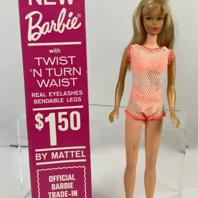 Sale Photo Thumbnail #112: Vintage 1967 Twist 'N Turn Barbie doll in original pink mesh swimsuit, accompanied by her original box displaying the trade-in program text.