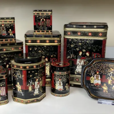 Sale Photo Thumbnail #44: Collection of vintage black, red, and gold chinoiserie tin canisters and a matching tray featuring Asian figure motifs.