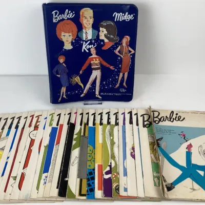 Sale Photo Thumbnail #179: Vintage 1960s Mattel Barbie, Ken, and Midge blue vinyl binder with a large stack of original Barbie magazines.