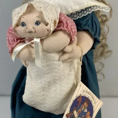 Sale Photo Thumbnail #119: Vintage Jan Shackelford Originals soft sculpture cloth doll holding a smaller baby doll, featuring blonde curly hair, detailed fabric clothing, and original hangtag.