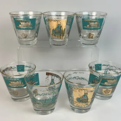 Sale Photo Thumbnail #43: Set of seven vintage mid-century lowball glasses featuring teal and gold riverboat graphics with gold rims.