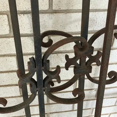 Sale Photo Thumbnail #234: Vintage wrought iron gate or architectural fence panel featuring decorative scrollwork detail and a rusted finish.
