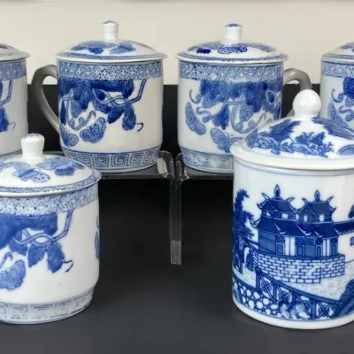 Sale Photo Thumbnail #228: Set of six Chinese blue and white porcelain lidded tea mugs, featuring floral, butterfly, and landscape motifs.