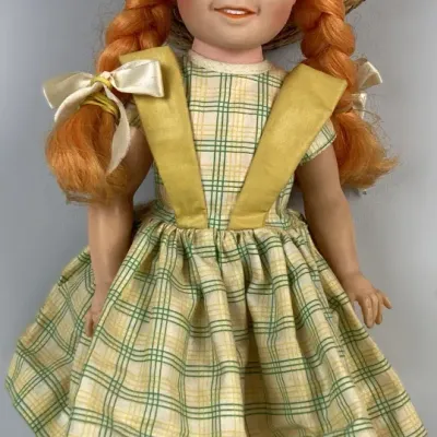 Sale Photo Thumbnail #123: Vintage Ideal 'Chatty Cathy' doll featuring red pigtails, freckles, a woven straw hat, and original yellow and green plaid dress.