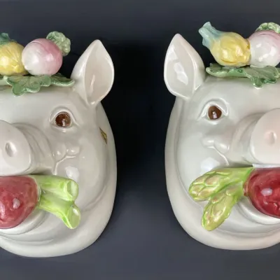 Sale Photo Thumbnail #49: Pair of vintage ceramic pig head wall pockets featuring hand-painted vegetable accents, including apples, asparagus, and radishes.