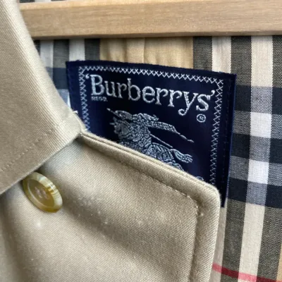 Sale Photo Thumbnail #157: Vintage Burberrys' trench coat featuring classic Nova check lining and original embroidered tag.