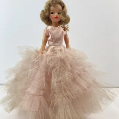 Sale Photo Thumbnail #141: Vintage Madame Alexander Cissy doll wearing a light pink satin and tiered tulle ballgown, featuring styled blonde hair and side-glancing painted eyes.