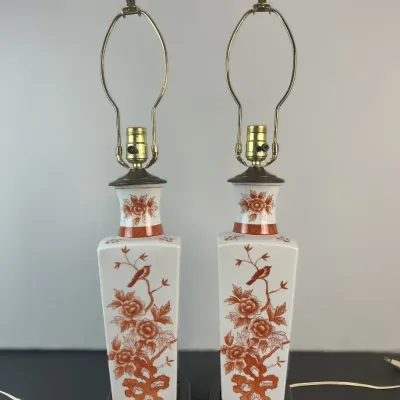 Sale Photo Thumbnail #9: Pair of vintage Asian-style porcelain table lamps featuring iron red bird and floral motifs on rectangular bases with decorative brass finials.