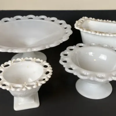 Sale Photo Thumbnail #37: Collection of four vintage white milk glass serving pieces, including open-lace edge compotes and a rectangular dish.