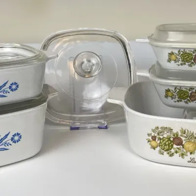 Sale Photo Thumbnail #48: Vintage Corning Ware casserole dishes and lid set, featuring Blue Cornflower and La Marjolaine spice motifs with clear glass covers.