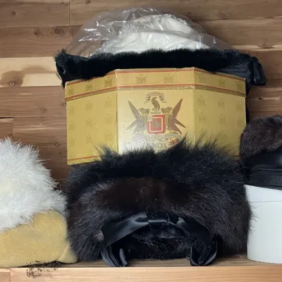 Sale Photo Thumbnail #145: Collection of vintage women's fur and feather hats, featuring a Knox hat box and various fur-trimmed headwear stored inside a cedar closet.