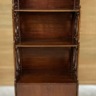 Sale Photo Thumbnail #57: Vintage dark wood display cabinet with open shelves, fretwork side accents, and a lower two-door storage compartment.