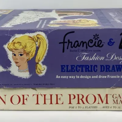 Sale Photo Thumbnail #178: Vintage 1960s Barbie "Queen of the Prom" board game by Mattel stacked under a Francie & Barbie Fashion Designer Electric Drawing Set by Lakeside Toys.