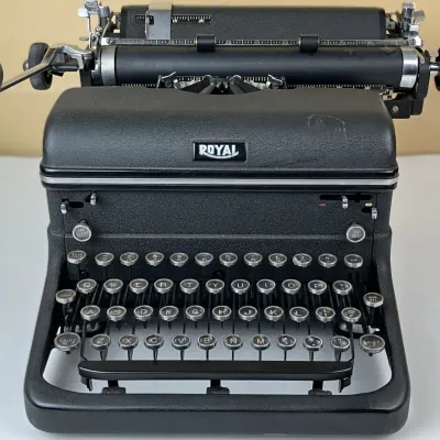 Sale Photo Thumbnail #109: Vintage Royal KMM manual typewriter featuring a textured black metal body and glass tombstone keys, circa 1940s.