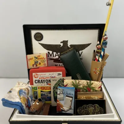 Sale Photo Thumbnail #192: Collection of vintage smalls, including a Sterling Utility Crayon case, a Cross pen case, Donald Duck matchbox, novelty pencils, and small collectibles displayed inside an open cigar box.