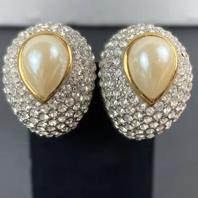 Sale Photo Thumbnail #20: Vintage bold clip-on earrings featuring pave-set rhinestones surrounding central tear-drop faux pearls in gold-tone bezel settings.