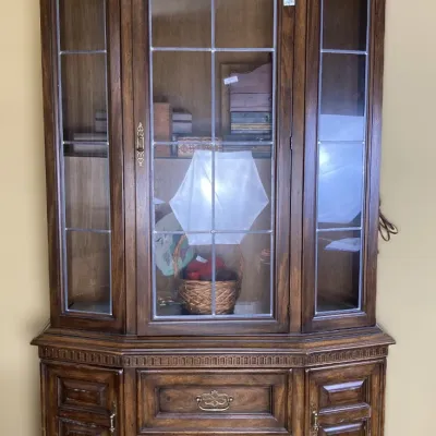 Sale Photo Thumbnail #83: Vintage dark wood china cabinet featuring leaded glass doors, lower storage drawers, and side cabinets, in good condition.