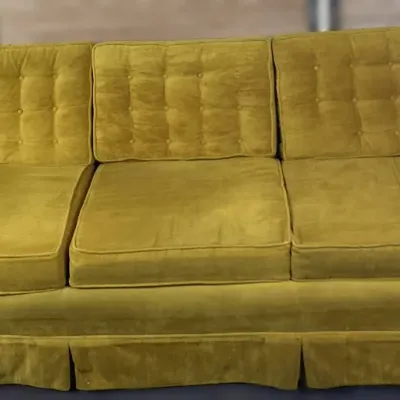 Sale Photo Thumbnail #133: Vintage mid-century mustard yellow velvet three-cushion sofa featuring tufted back cushions and a pleated base skirt.