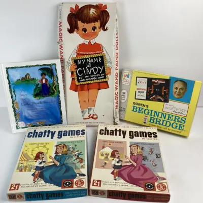 Sale Photo Thumbnail #188: Collection of vintage games and children's items, including two 1960s Mattel Chatty Games boxed sets, a Magic Wand paper doll set, Goren's Beginners Bridge, and a picture book.