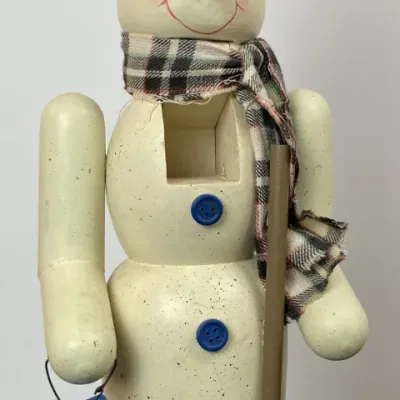 Sale Photo Thumbnail #206: Vintage wooden snowman nutcracker featuring a plaid scarf, black top hat with bird detail, miniature broom, and birdhouse accessory.