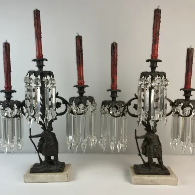 Sale Photo Thumbnail #8: Pair of antique bronze 3-light girandole candelabras featuring figure bases, marble plinths, crystal prism drops, and red wax candles.