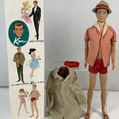 Sale Photo Thumbnail #117: Vintage 1960s Mattel Ken doll with painted flock hair, wearing a striped beach outfit and straw hat, complete with original box and additional plaid-lined trench coat outfit.