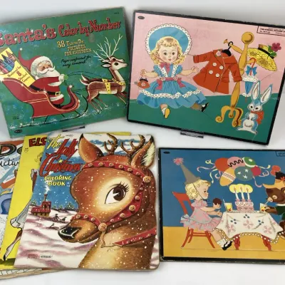 Sale Photo Thumbnail #181: Collection of vintage 1950s children's coloring books, activity books, and Whitman frame-tray wooden puzzles featuring Christmas and play themes.