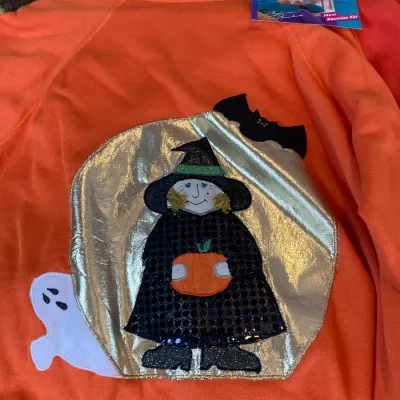 Sale Photo Thumbnail #152: Vintage bright orange Hanes Her Way Halloween sweatshirt featuring a metallic full moon applique, embroidered witch holding a pumpkin, bat, and ghost graphic.