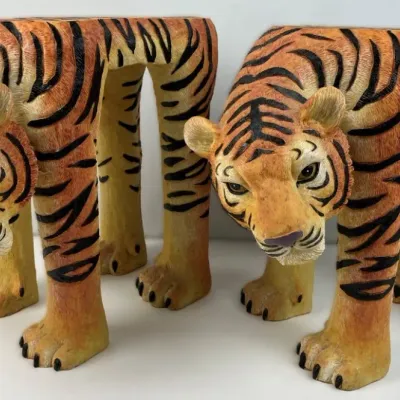 Sale Photo Thumbnail #196: Pair of novelty hand-painted tiger-shaped wooden stools or plant stands with flat back tops, shown in good condition.