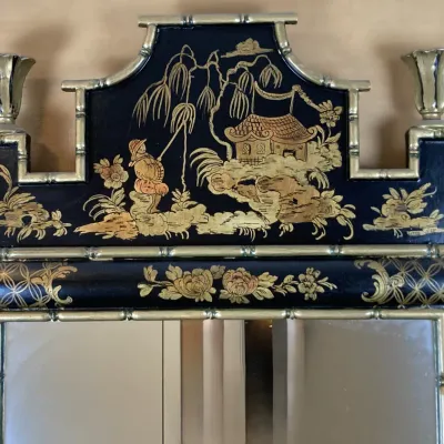 Sale Photo Thumbnail #131: Chinoiserie wall mirror with black lacquer finish, hand-painted gilt landscape pediment, and faux bamboo brass frame detailing.