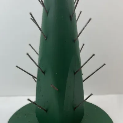 Sale Photo Thumbnail #217: Novelty green wooden cactus-shaped toothpick or hors d'oeuvre holder with protruding metal pins on a round base.