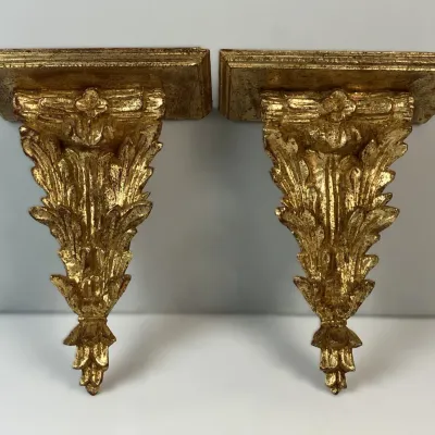 Sale Photo Thumbnail #132: Pair of vintage gold-gilt wall corbel shelves featuring detailed acanthus leaf carvings and a distressed finish.
