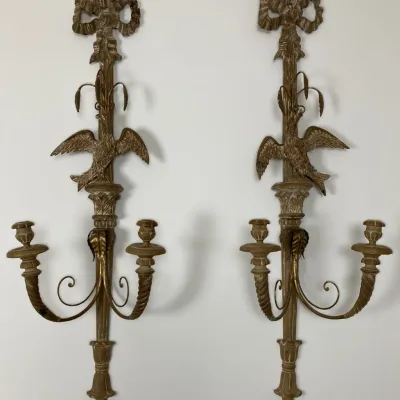 Sale Photo Thumbnail #2: Pair of Neoclassical style gilded wall sconces featuring ribbon crests, bird motifs, and two candle arms each.