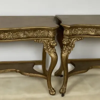 Sale Photo Thumbnail #12: Pair of ornate giltwood console tables in the Baroque style, featuring intricate carved apron scrollwork, cabriole legs, and lower stretchers.