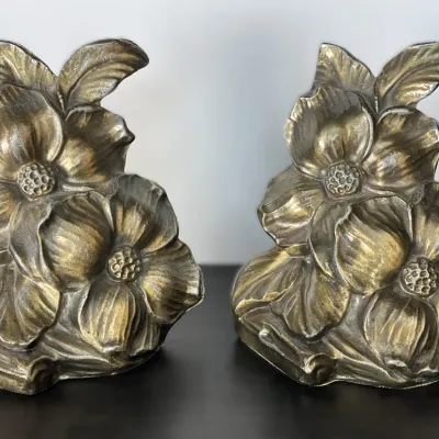 Sale Photo Thumbnail #67: Pair of vintage heavy brass or bronze bookends featuring sculpted dogwood flowers and leaves, showing a warm aged patina.