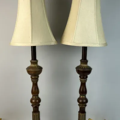 Sale Photo Thumbnail #91: Pair of traditional tall table lamps featuring turned wood shafts with brass accents, ornate base trim, and cream fabric bell shades.
