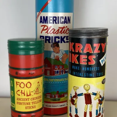 Sale Photo Thumbnail #189: Trio of vintage toy and game canisters, including Halsam American Plastic Bricks, Whitman Krazy Ikes, and Foo Chu Ancient Chinese Fortune Telling Sticks.