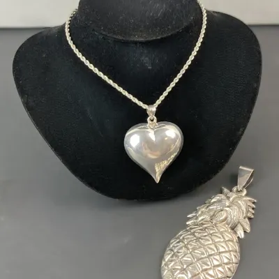 Sale Photo Thumbnail #22: Sterling silver puffed heart pendant necklace on a rope chain, paired with a detailed sterling silver pineapple pendant.