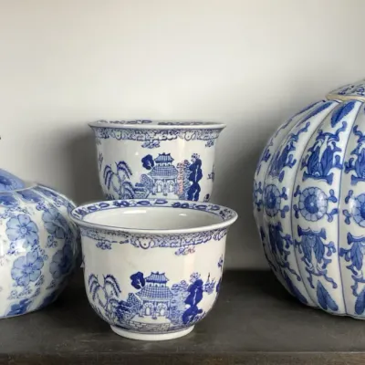 Sale Photo Thumbnail #77: Collection of blue and white Chinese-style porcelain, including two pumpkin-shaped lidded jars and two Blue Willow pattern planters.