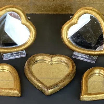 Sale Photo Thumbnail #167: Set of five heart-shaped mirrors in gilt frames of varying sizes, showing light vintage wear.