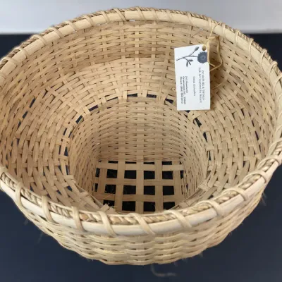 Sale Photo Thumbnail #225: Handwoven natural splint basket with openwork base and wrapped rim, featuring an artisan tag from Of Nature & Things by Dana Gonzalez.