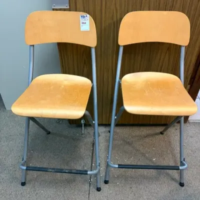 Pair of modern folding bar stools featuring light wooden seats and backrests paired with silver metal frames.
