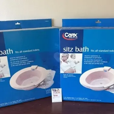 Two boxed Carex sitz bath kits, designed to fit standard toilets for personal hygiene care.